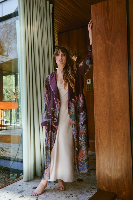Navy blue dressing gown with colourful parsley seed plants all over from one hundred stars model shot