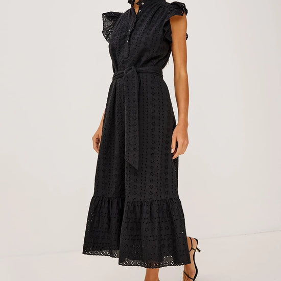 Woman wearing a black dress with ruffled sleeves on a white background from rails