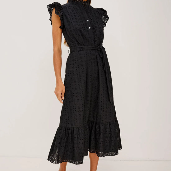 Woman wearing a black dress with ruffled sleeves on a white background from rails