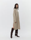 Beige wool dress with a funnel neck and long sleeves model shot with boots