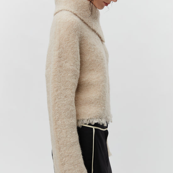 Cream boucle wool jumper with asymetric neckline detail side view