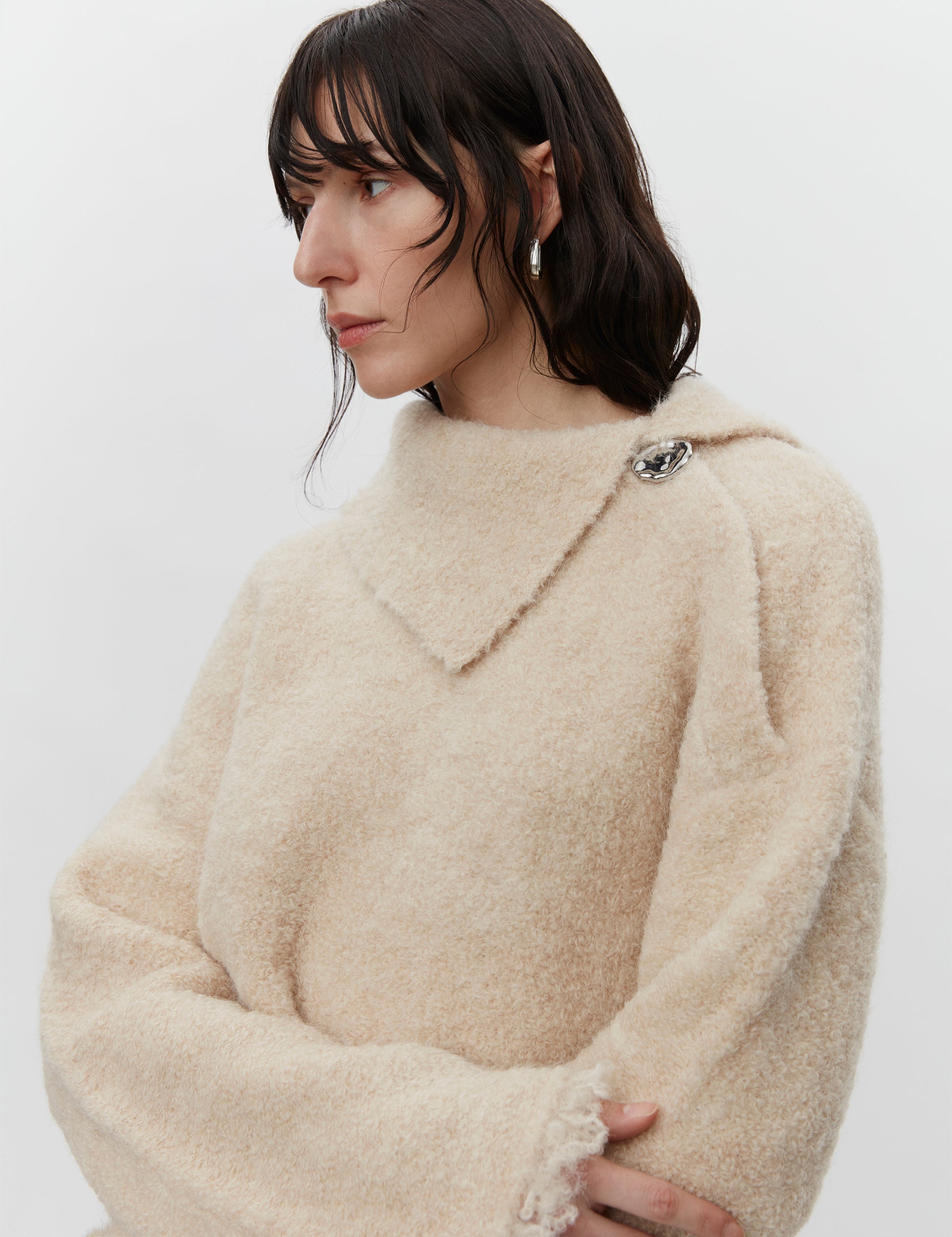 Cream boucle wool jumper with asymetric neckline detail close up