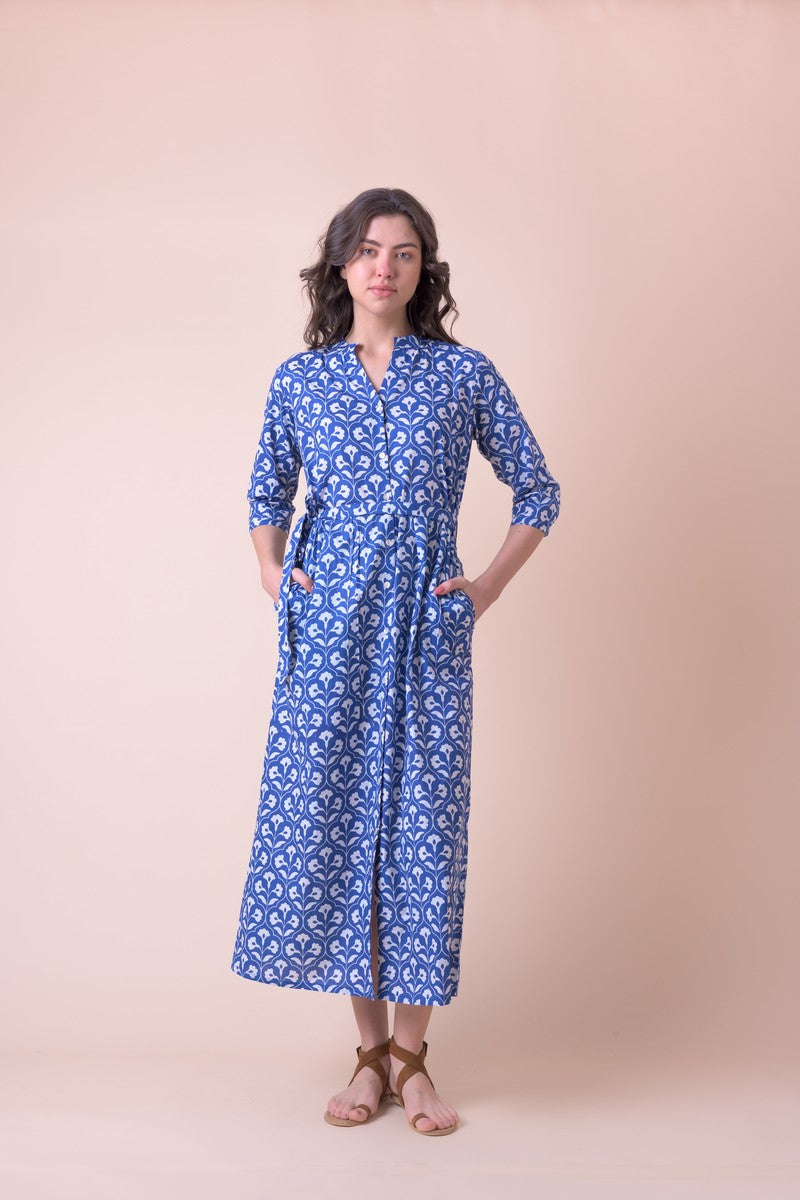 Blue midi shirt dress with half placket grandad collar and three quarter sleeves with a tie belt and white all over floral print