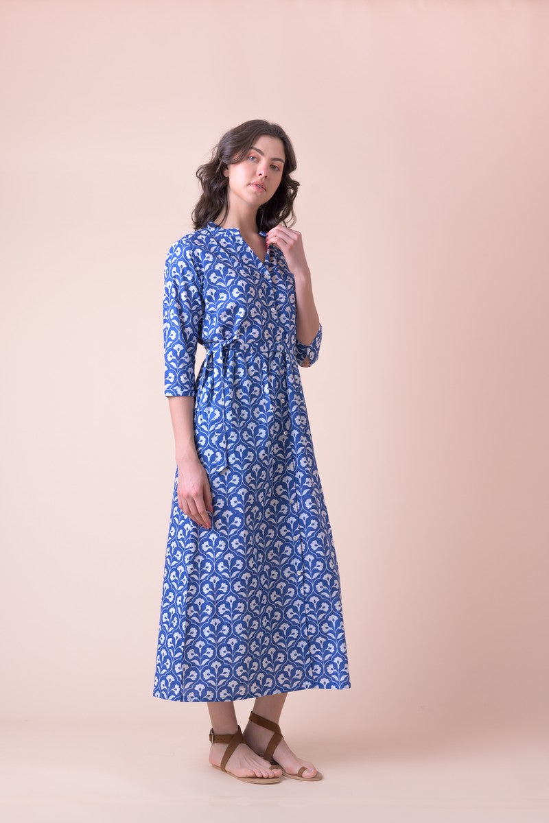 Blue midi shirt dress with half placket grandad collar and three quarter sleeves with a tie belt and white all over floral print