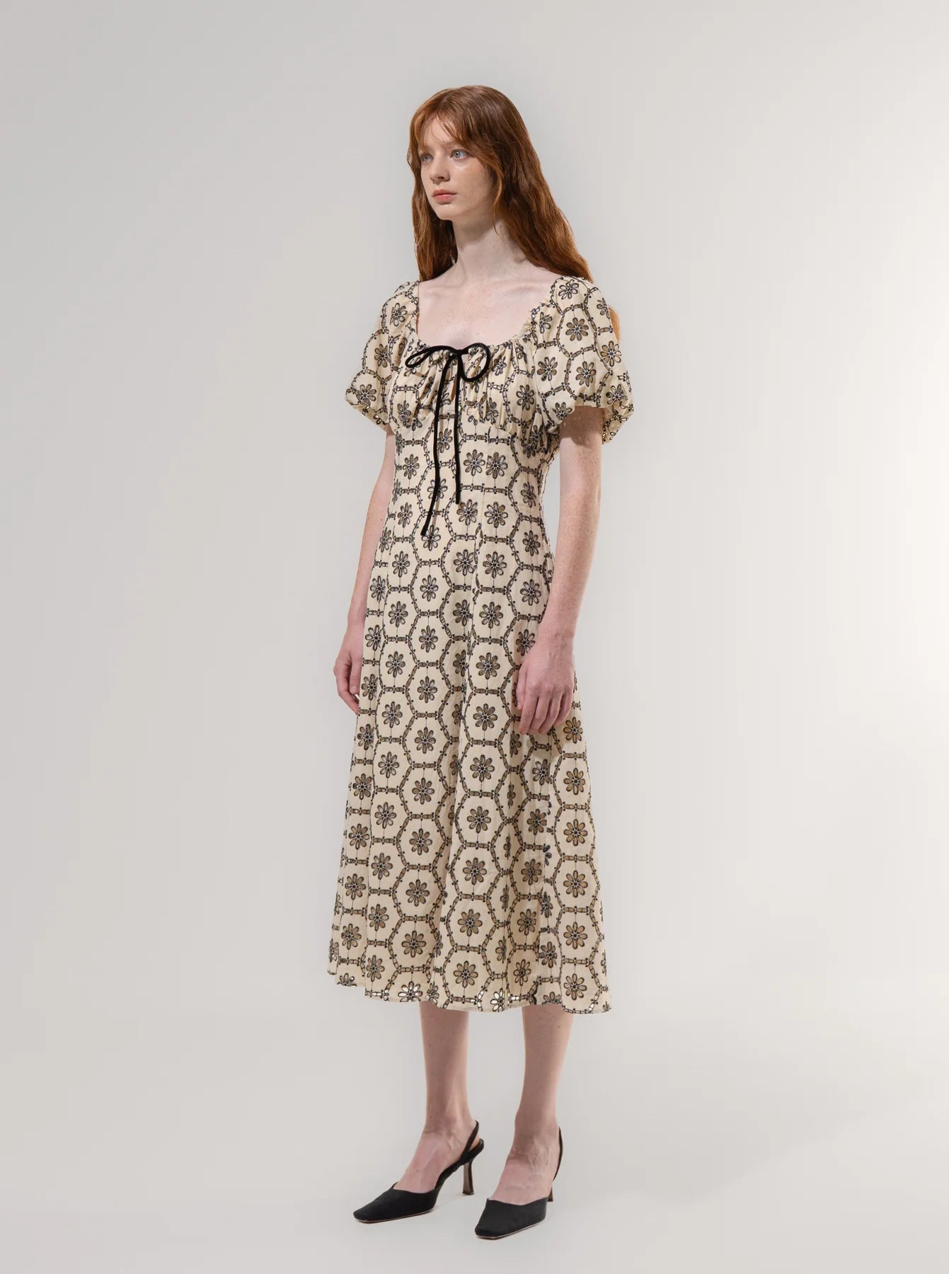 Woman wearing a floral dress on a white background