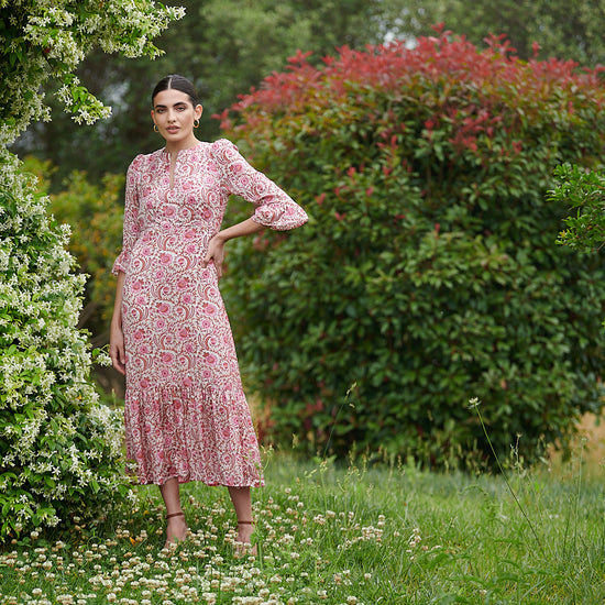 Pink floral midi dress with slash neckline three quarter sleeves with ruffle detail empire line and deep ruffle hem