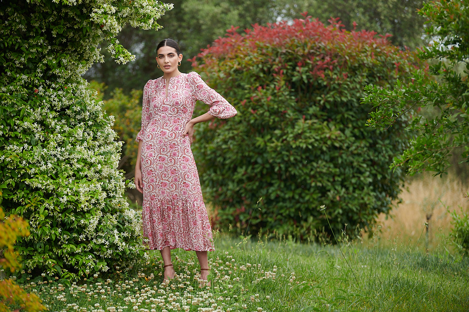 Pink floral midi dress with slash neckline three quarter sleeves with ruffle detail empire line and deep ruffle hem