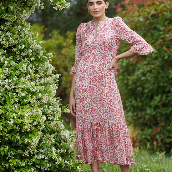 Pink floral midi dress with slash neckline three quarter sleeves with ruffle detail empire line and deep ruffle hem