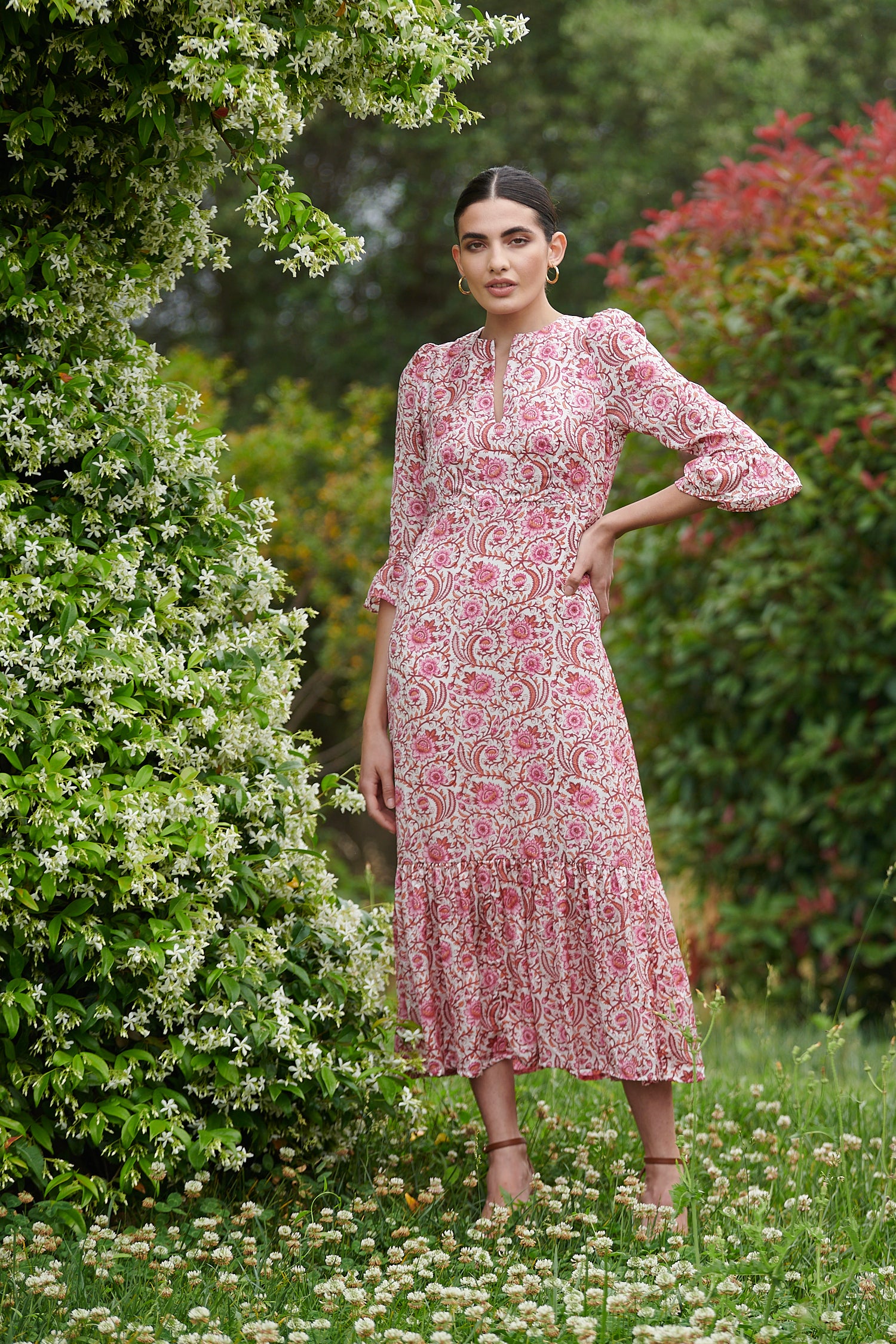 Pink floral midi dress with slash neckline three quarter sleeves with ruffle detail empire line and deep ruffle hem