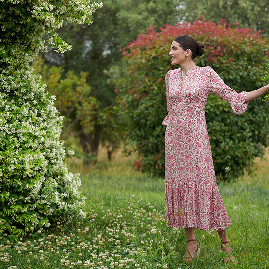 Pink floral midi dress with slash neckline three quarter sleeves with ruffle detail empire line and deep ruffle hem