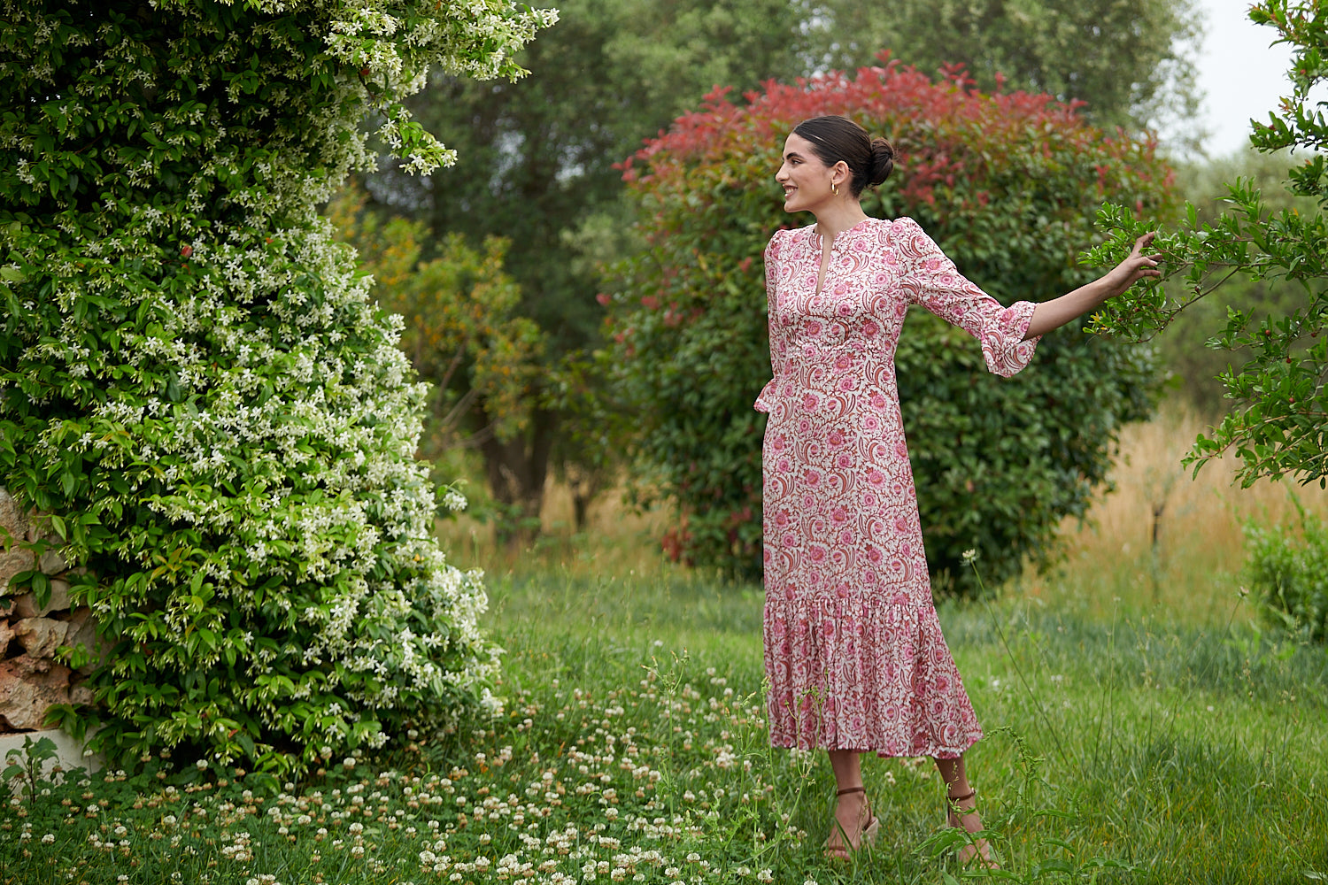 Pink floral midi dress with slash neckline three quarter sleeves with ruffle detail empire line and deep ruffle hem