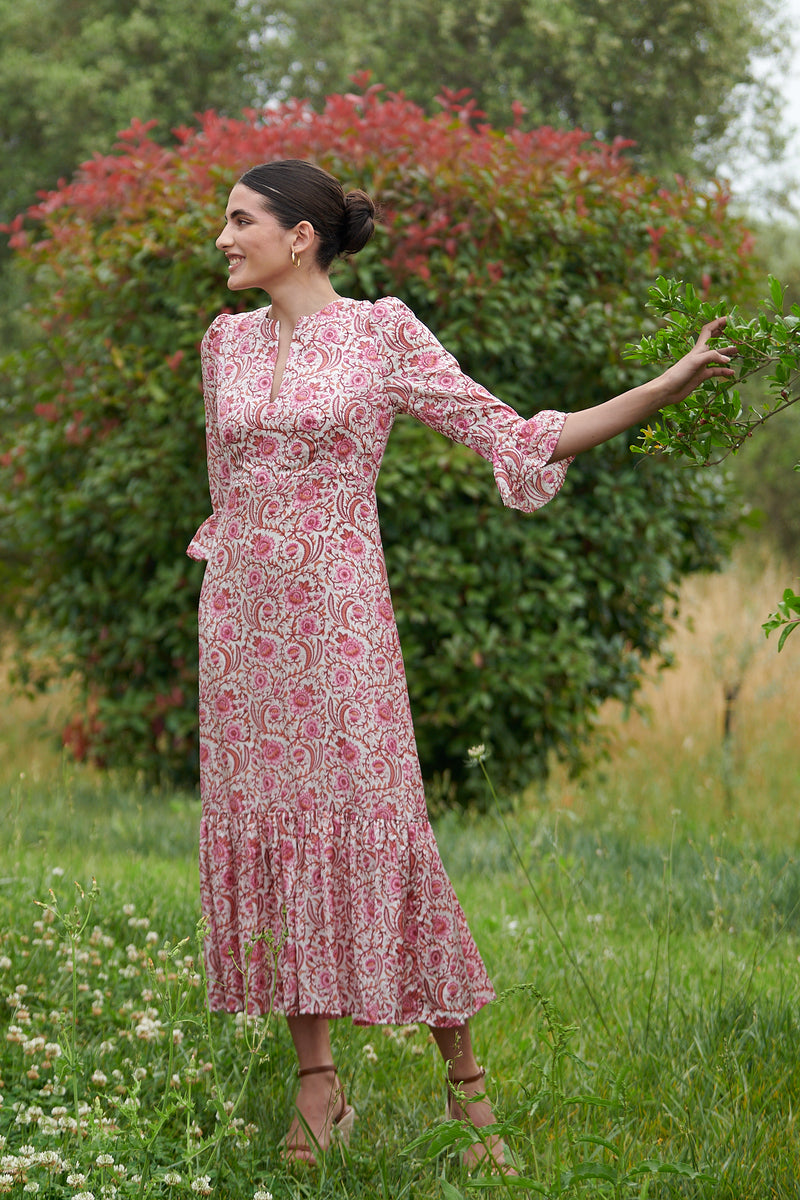 Pink floral midi dress with slash neckline three quarter sleeves with ruffle detail empire line and deep ruffle hem