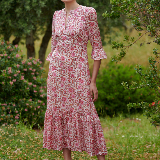 Pink floral midi dress with slash neckline three quarter sleeves with ruffle detail empire line and deep ruffle hem