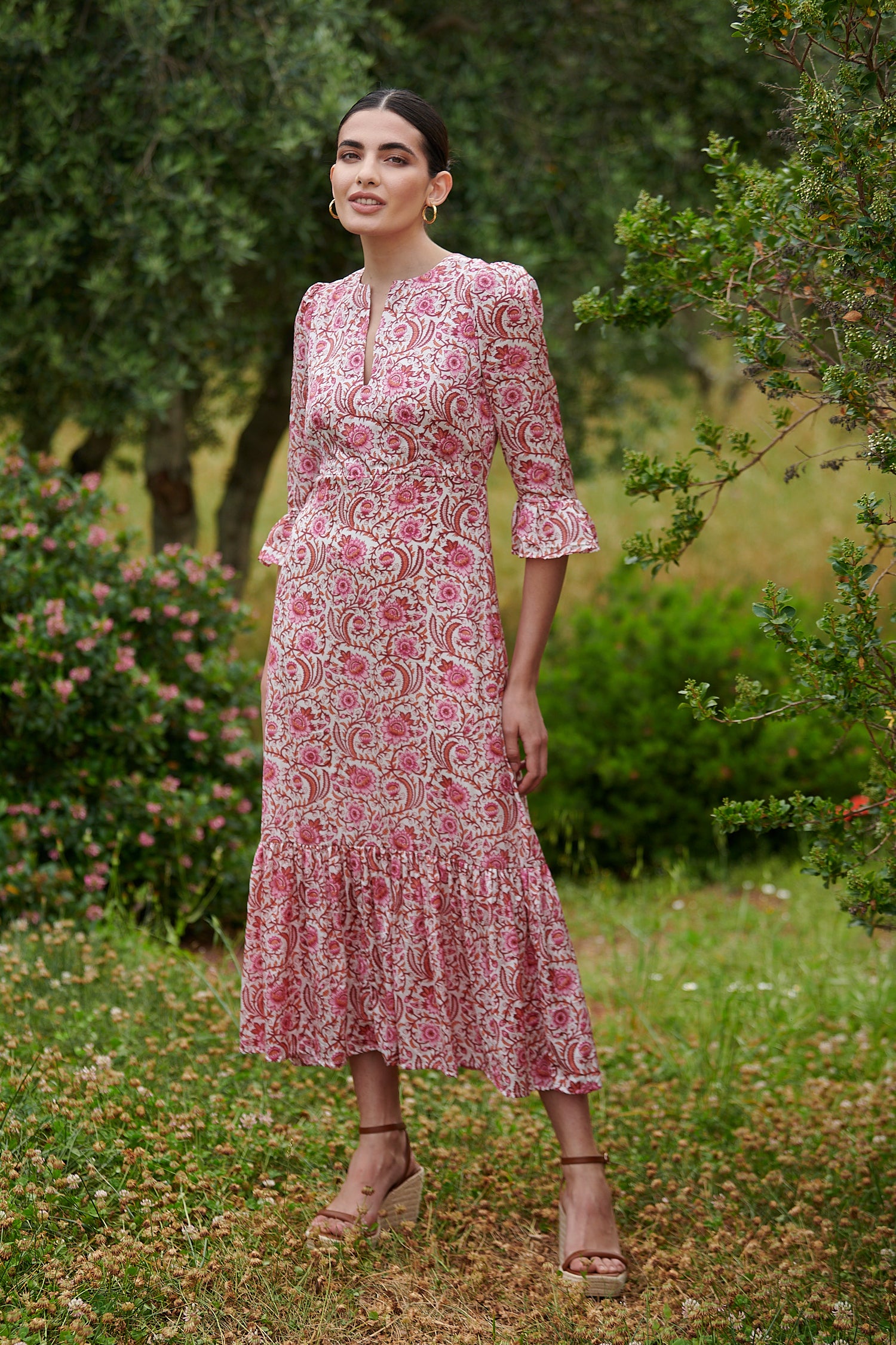 Pink floral midi dress with slash neckline three quarter sleeves with ruffle detail empire line and deep ruffle hem