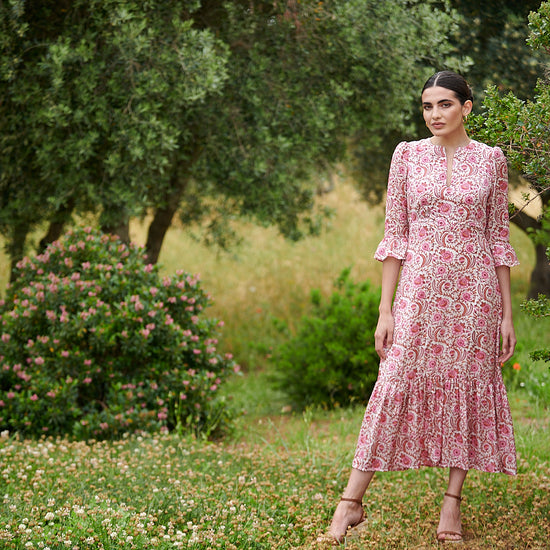 Pink floral midi dress with slash neckline three quarter sleeves with ruffle detail empire line and deep ruffle hem