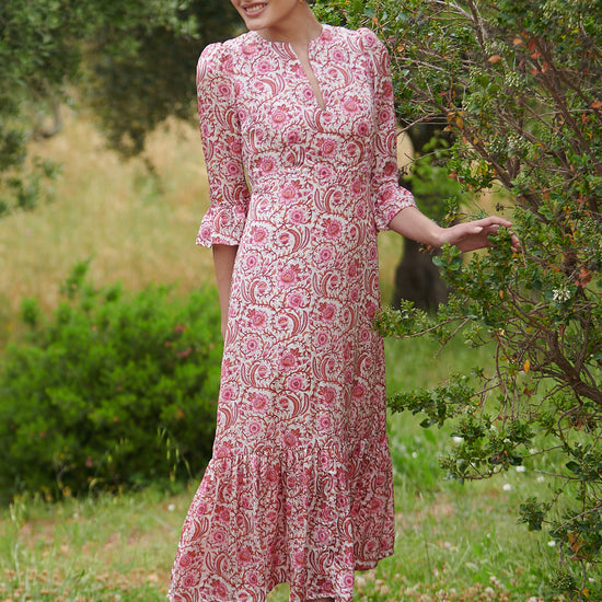 Pink floral midi dress with slash neckline three quarter sleeves with ruffle detail empire line and deep ruffle hem