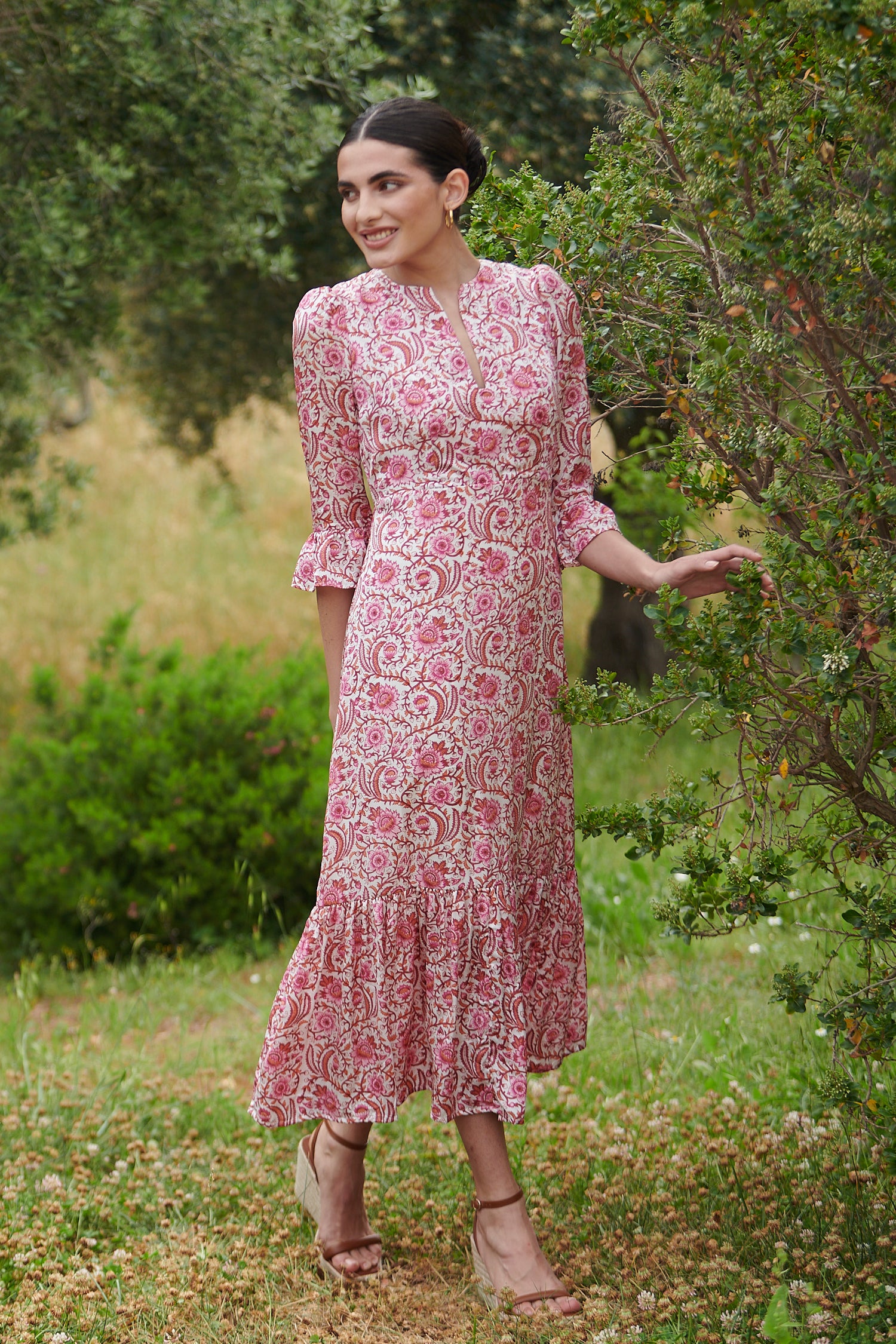 Pink floral midi dress with slash neckline three quarter sleeves with ruffle detail empire line and deep ruffle hem