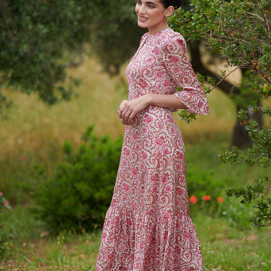 Pink floral midi dress with slash neckline three quarter sleeves with ruffle detail empire line and deep ruffle hem