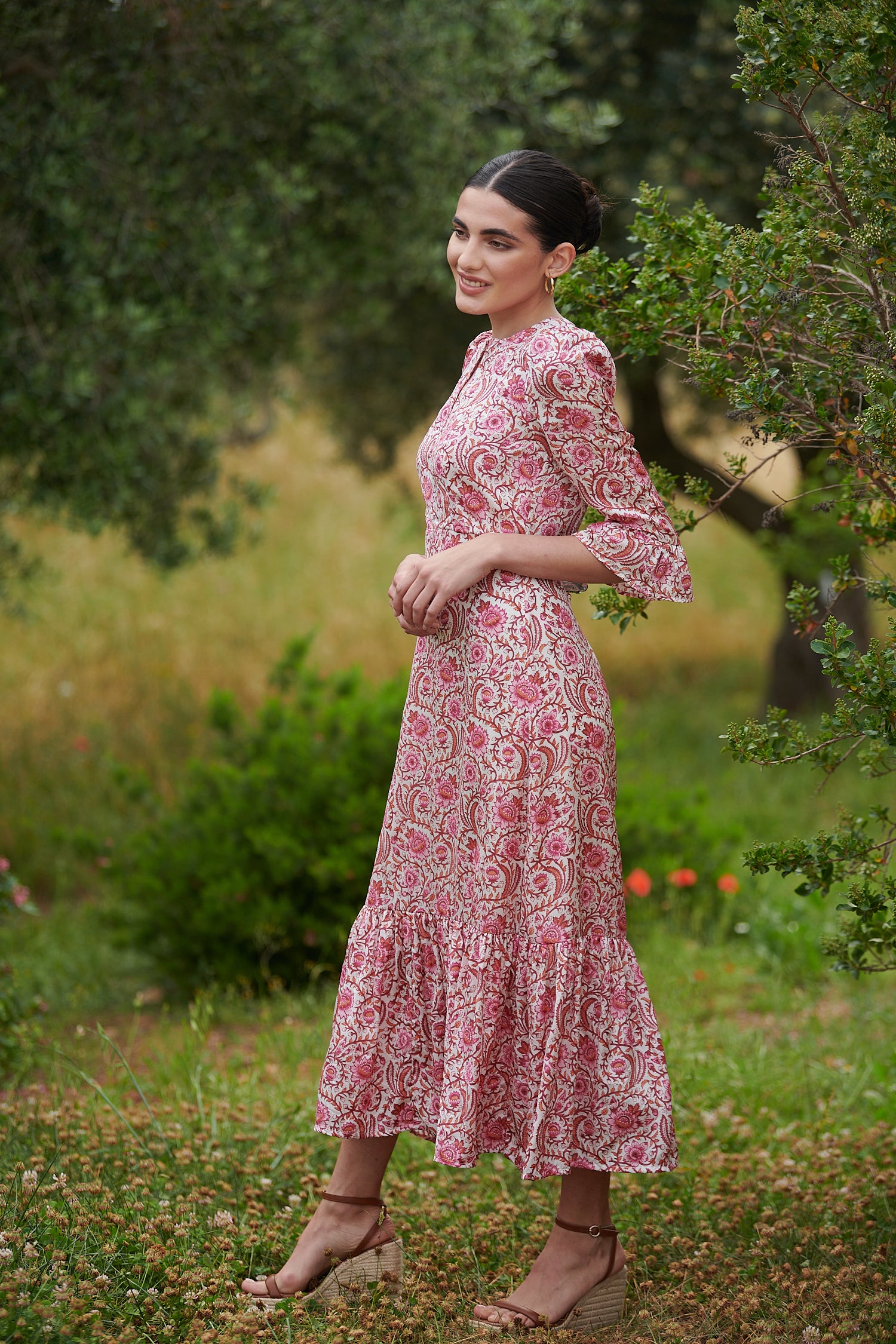 Pink floral midi dress with slash neckline three quarter sleeves with ruffle detail empire line and deep ruffle hem