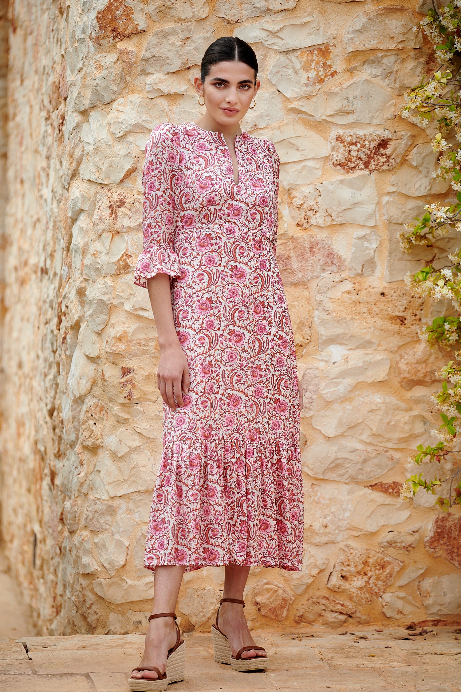 Pink floral midi dress with slash neckline three quarter sleeves with ruffle detail empire line and deep ruffle hem