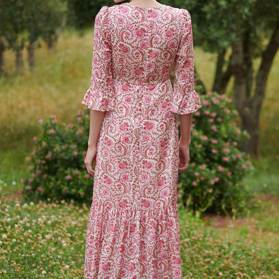 Pink floral midi dress with slash neckline three quarter sleeves with ruffle detail empire line and deep ruffle hem