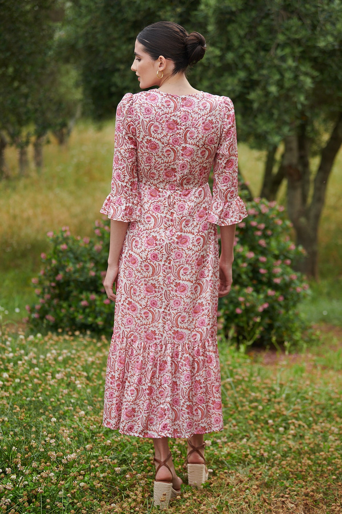 Pink floral midi dress with slash neckline three quarter sleeves with ruffle detail empire line and deep ruffle hem