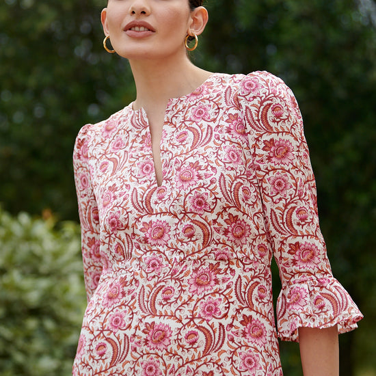 Pink floral midi dress with slash neckline three quarter sleeves with ruffle detail empire line and deep ruffle hem