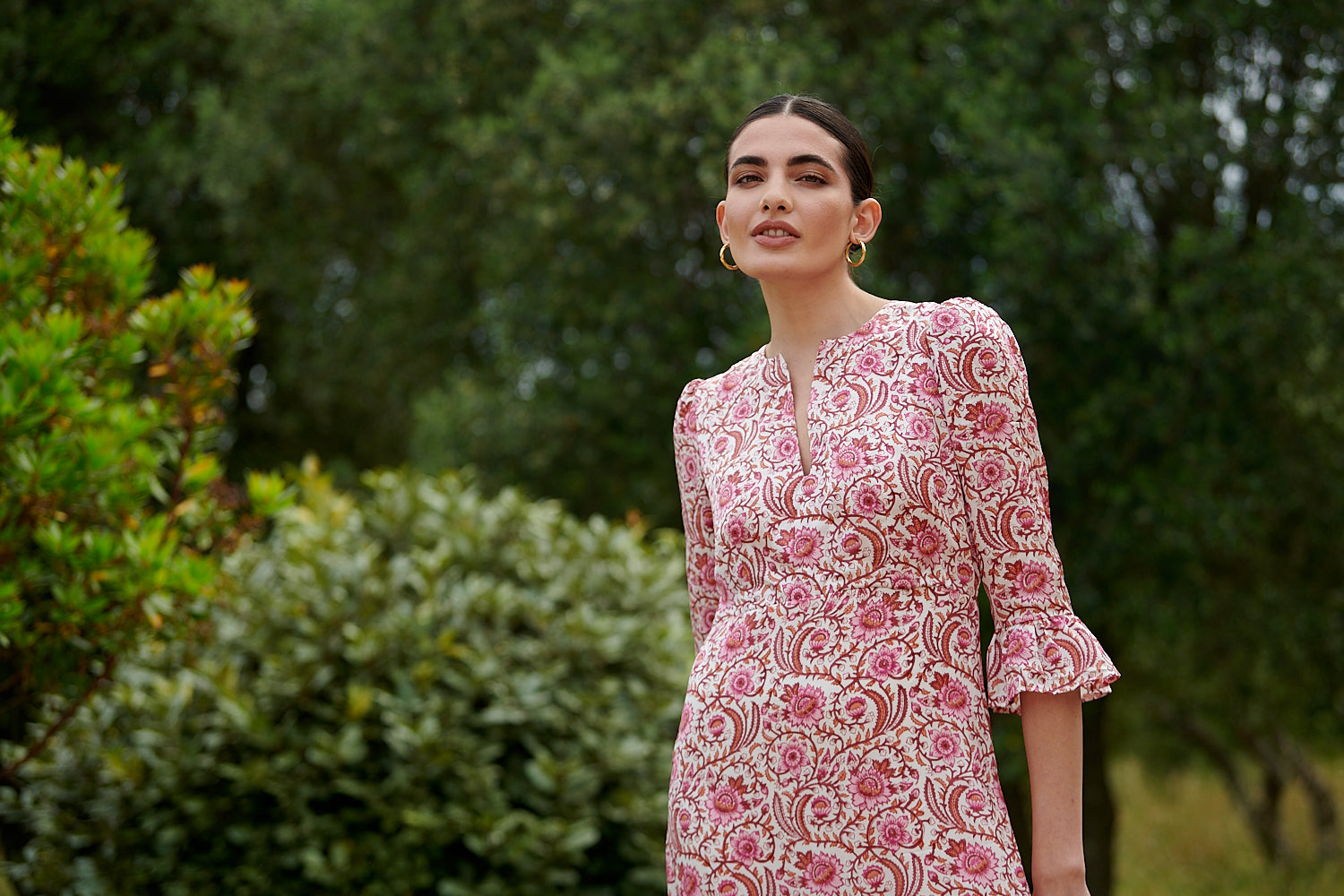 Pink floral midi dress with slash neckline three quarter sleeves with ruffle detail empire line and deep ruffle hem