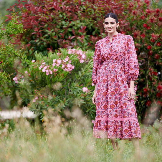 Pink midi dress with floral details with bracelet length sleeves mau collar covered button half placket elasticated waist with drawstring and gathered hem with lace inserts