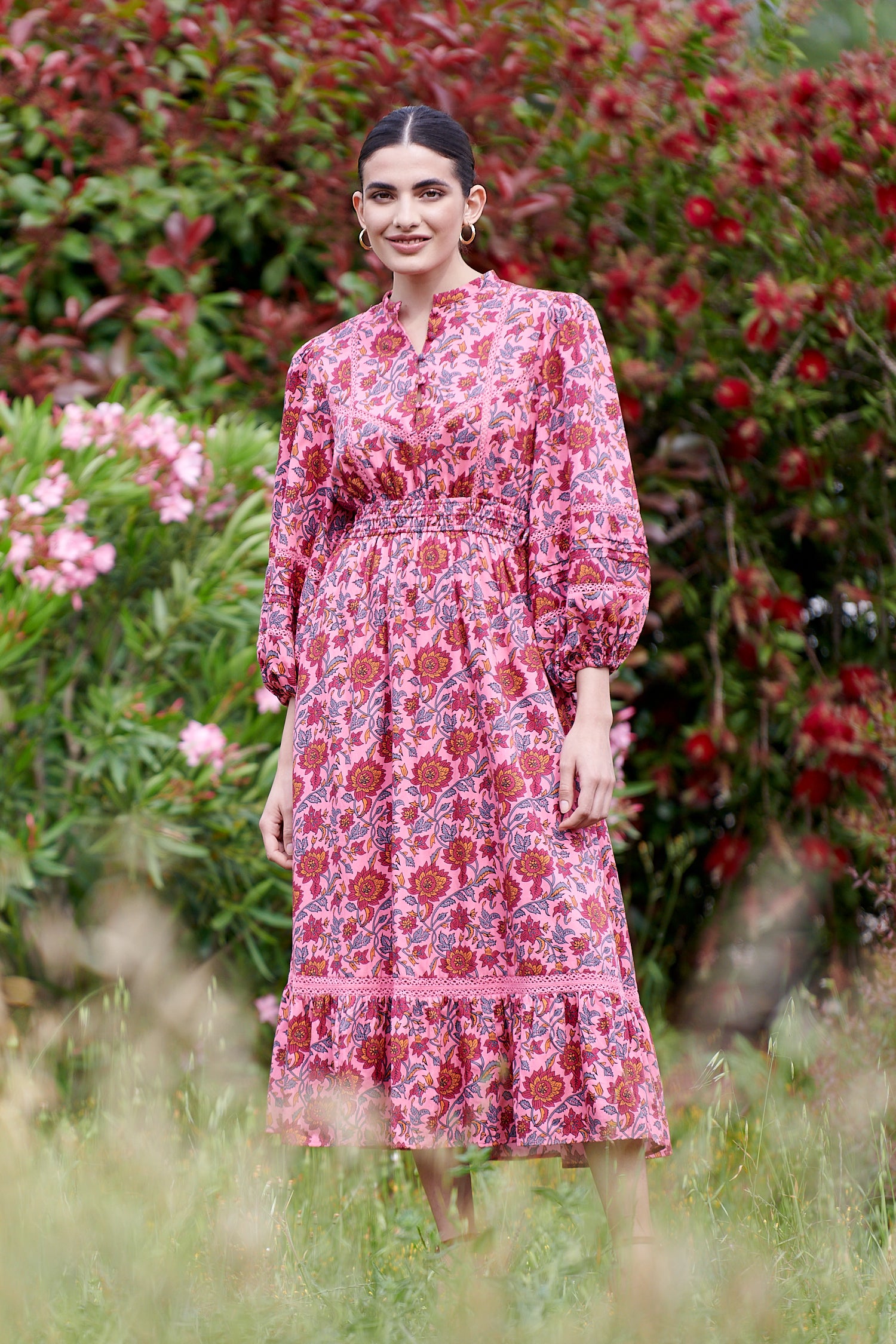 Pink midi dress with floral details with bracelet length sleeves mau collar covered button half placket elasticated waist with drawstring and gathered hem with lace inserts