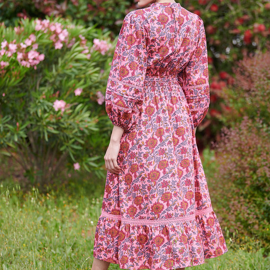 Pink midi dress with floral details with bracelet length sleeves mau collar covered button half placket elasticated waist with drawstring and gathered hem with lace inserts