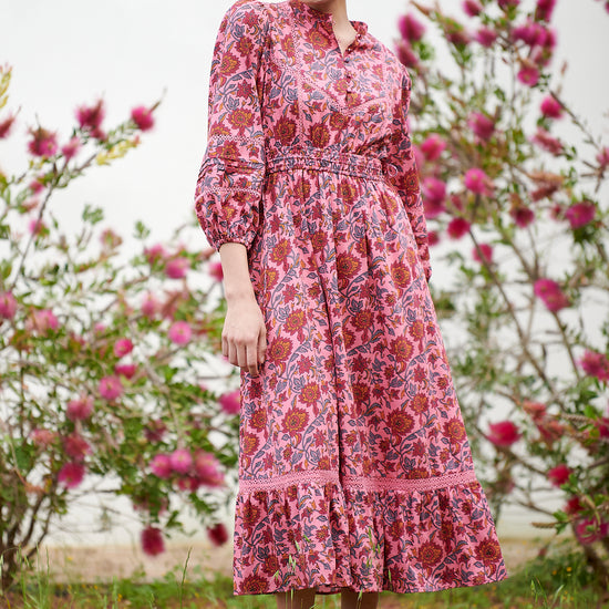 Pink midi dress with floral details with bracelet length sleeves mau collar covered button half placket elasticated waist with drawstring and gathered hem with lace inserts