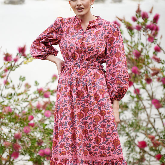 Pink midi dress with floral details with bracelet length sleeves mau collar covered button half placket elasticated waist with drawstring and gathered hem with lace inserts