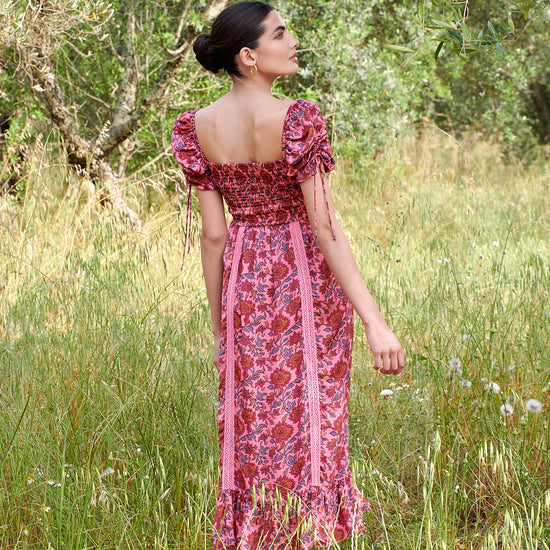 Pink midi dress with all over floral pattern square neckline and puff sleeves with elasticated cuffs and drawstring details