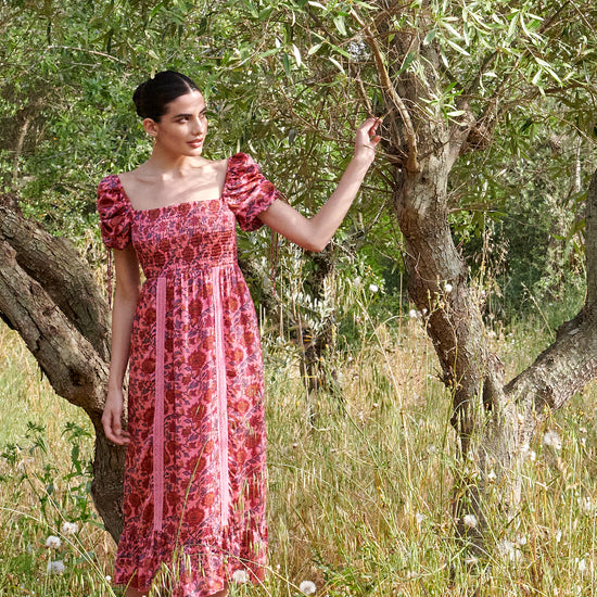 Pink midi dress with all over floral pattern square neckline and puff sleeves with elasticated cuffs and drawstring details