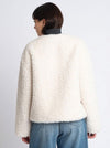 white faux fur cropped jacket with black buckle fastening and v neck rear view 