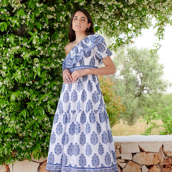 One shoulder midi dress with ruched waistline with white background and blue floral print