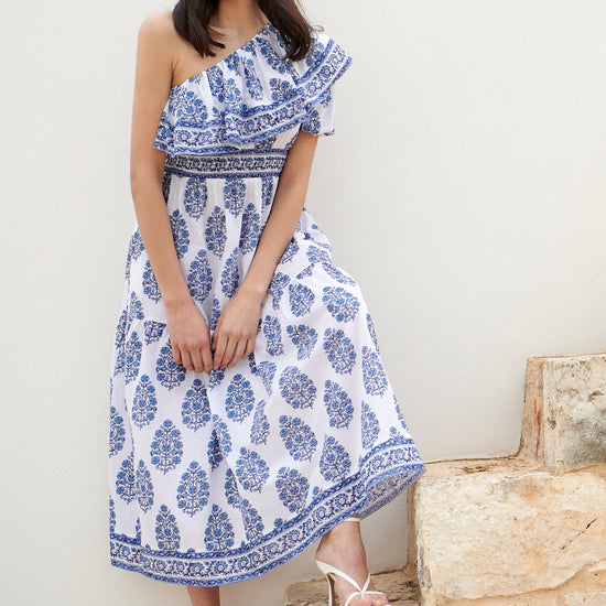 One shoulder midi dress with ruched waistline with white background and blue floral print