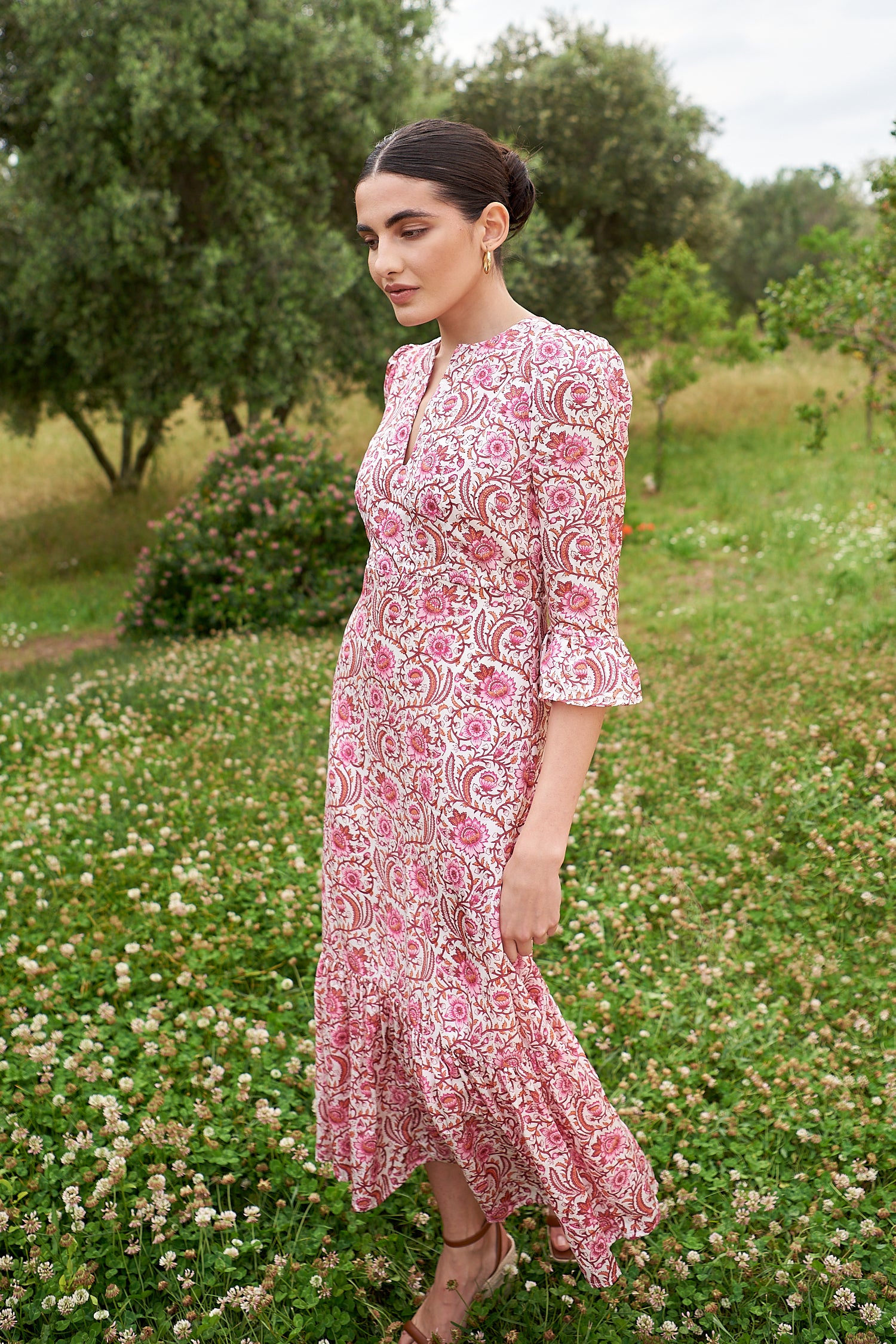 Pink floral midi dress with slash neckline three quarter sleeves with ruffle detail empire line and deep ruffle hem