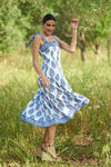 White dress with blue floral print with wide adjustable straps and tiered skirt