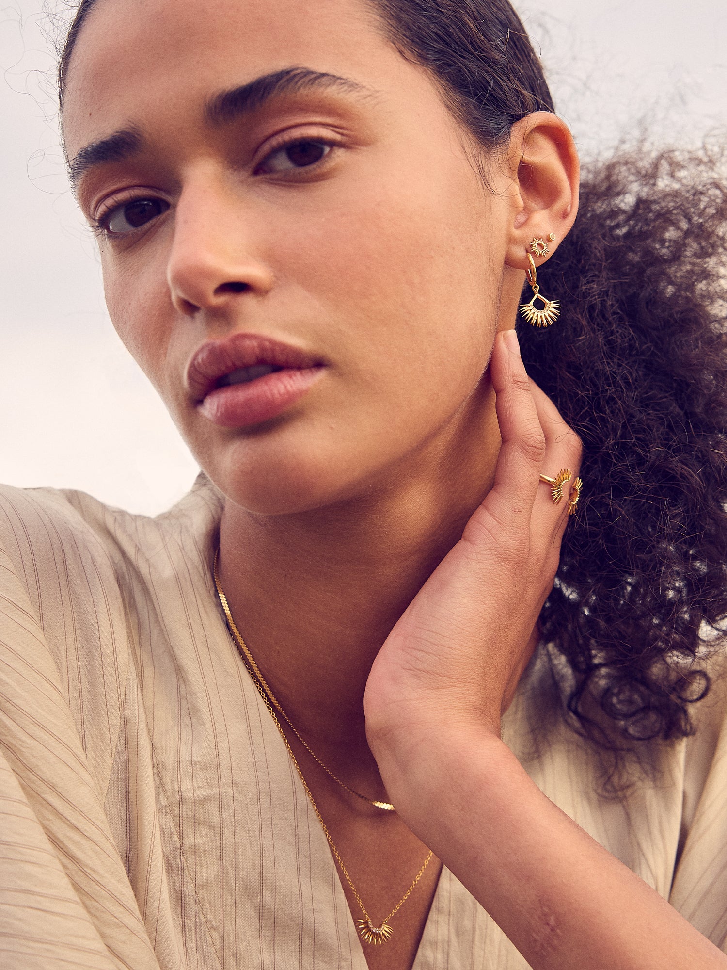 gold rising sun charm huggie earrings with diamante detailing from rachel jackson model shot