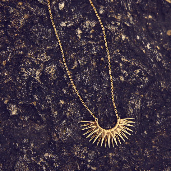 medium sized half sunshine with gold spikes on a delicate gold chain from rachel jackson 
