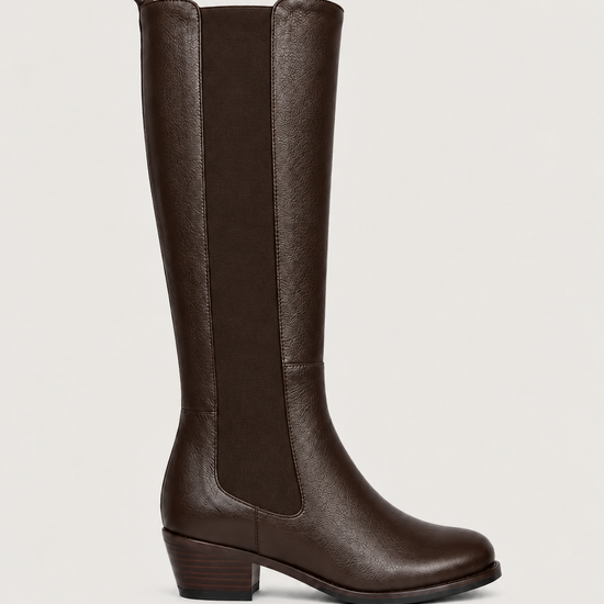 A brown leather knee-high boot with elastic side panels and a low block heel, shown in profile against a light gray background.