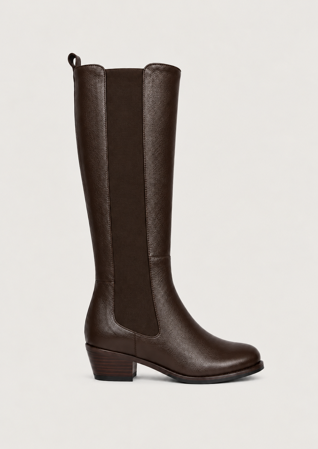 A brown leather knee-high boot with elastic side panels and a low block heel, shown in profile against a light gray background.