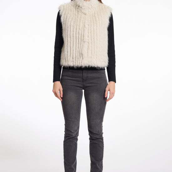 light beige faux fur sleeveless gilet with high neck, central closure and stripe detailing model shot