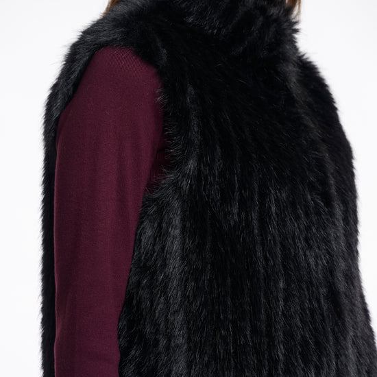 black faux fur sleeveless gilet with high neck, central closure and stripe detailing side view 