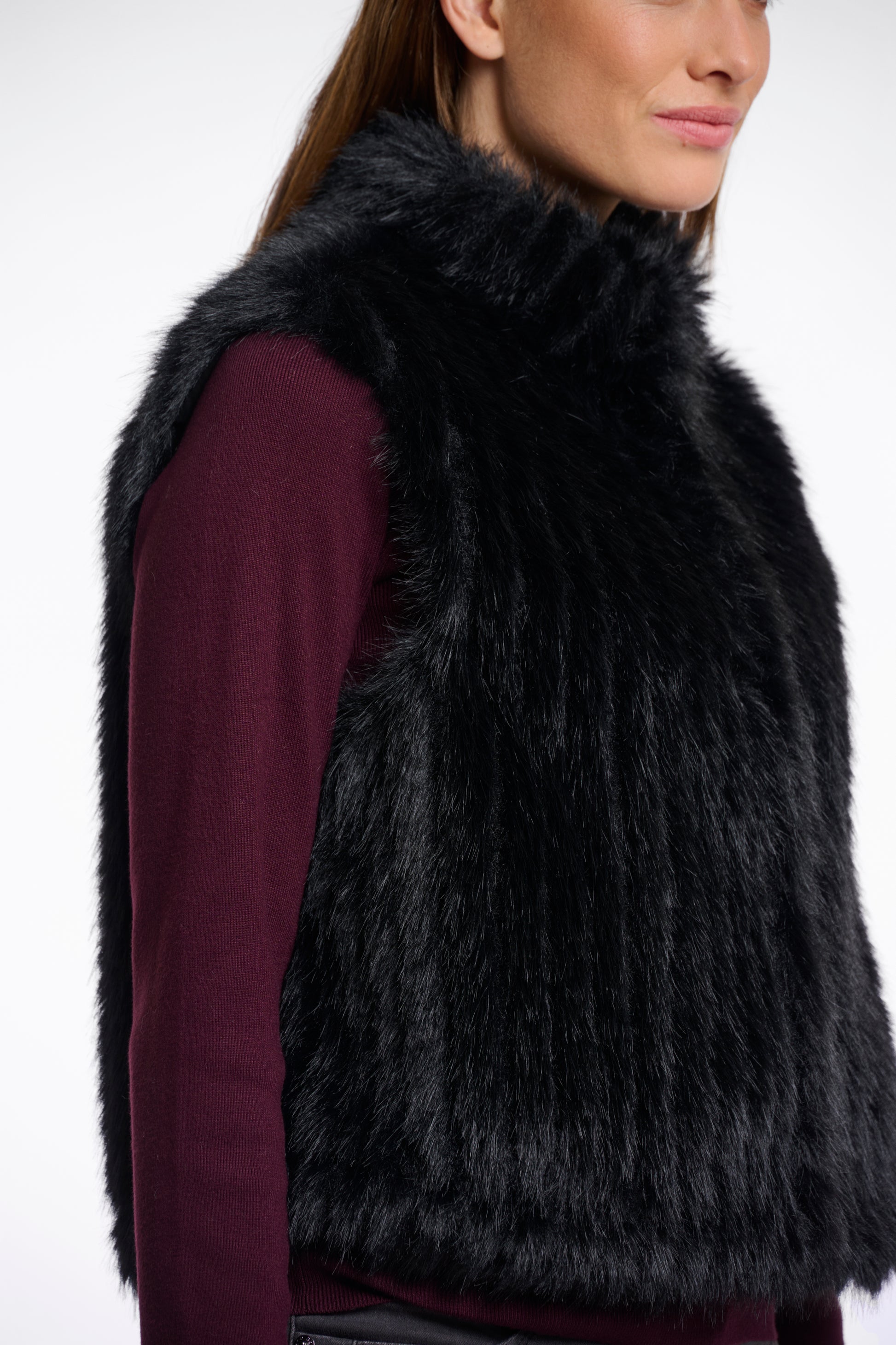 black faux fur sleeveless gilet with high neck, central closure and stripe detailing side view 