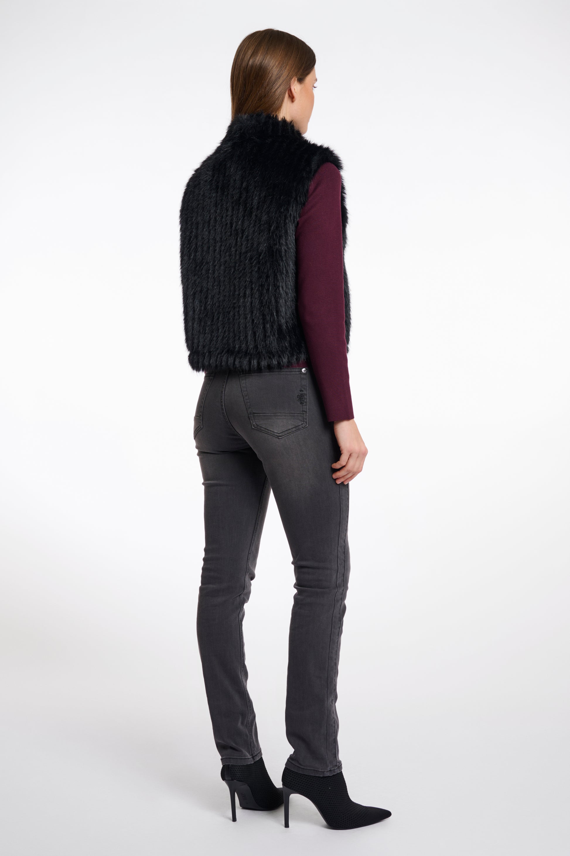 black faux fur sleeveless gilet with high neck, central closure and stripe detailing rear view 