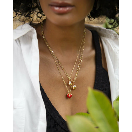 Gold pear pendant necklace on a dainty gold chain with pave diamond leaf