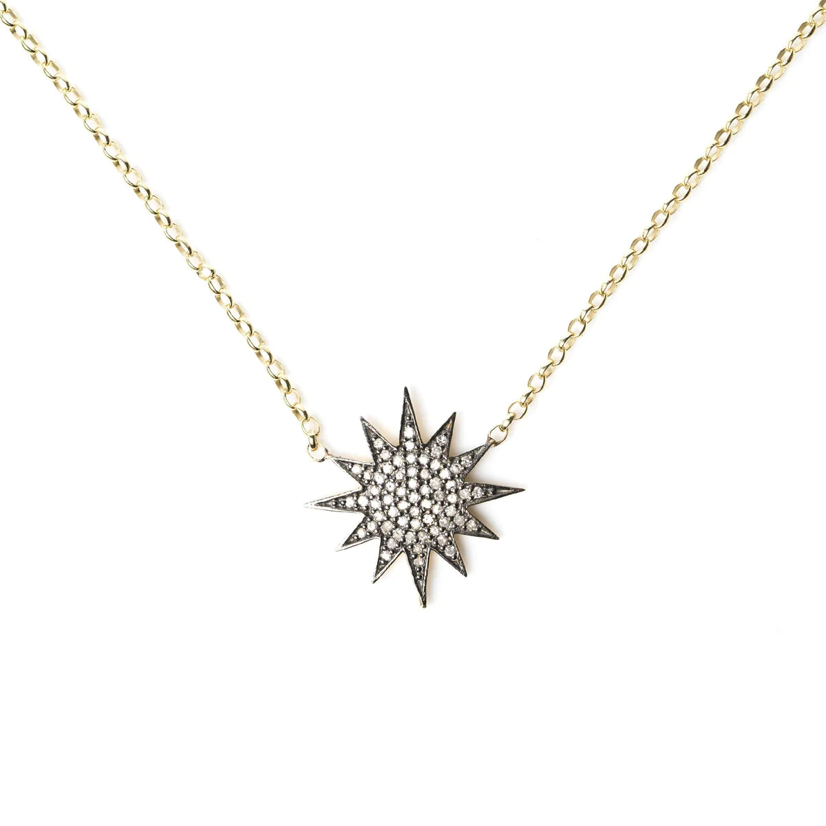 Gold chain with oxidised sterling silver starburst pendant with pave diamonds